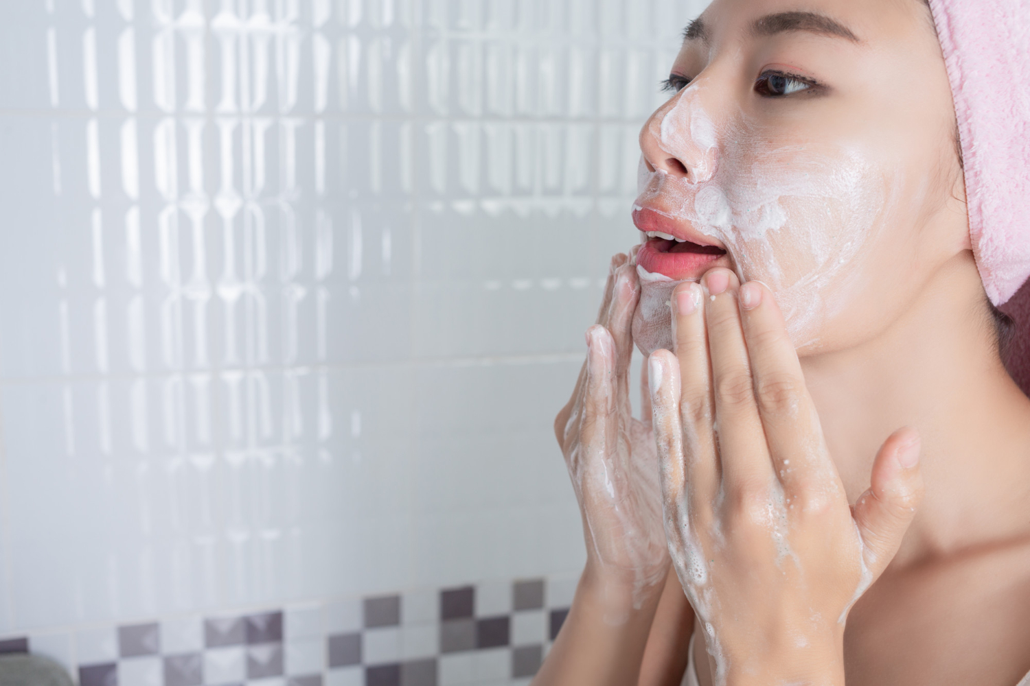woman cleaning her face