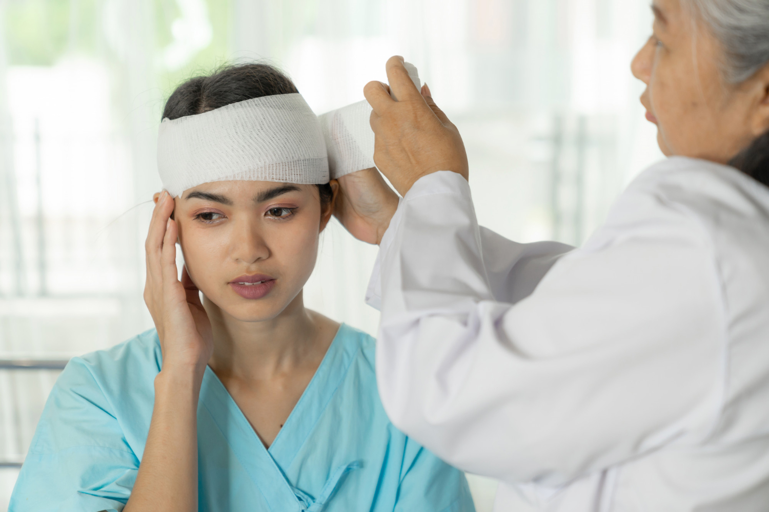 woman rebandaging her head