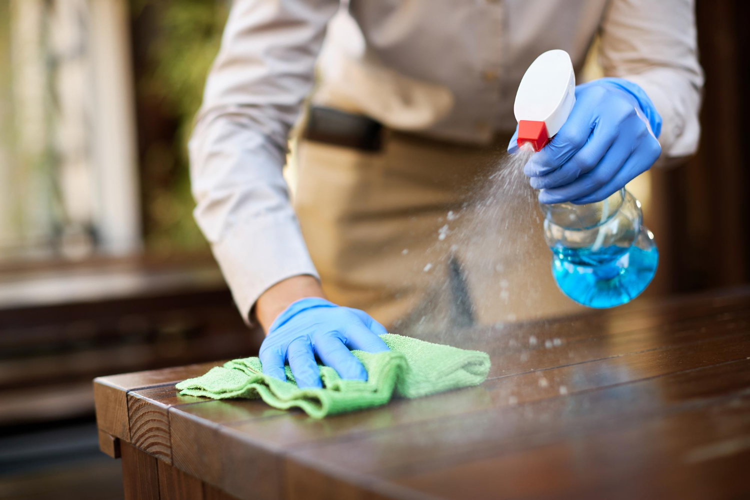person cleaning a table